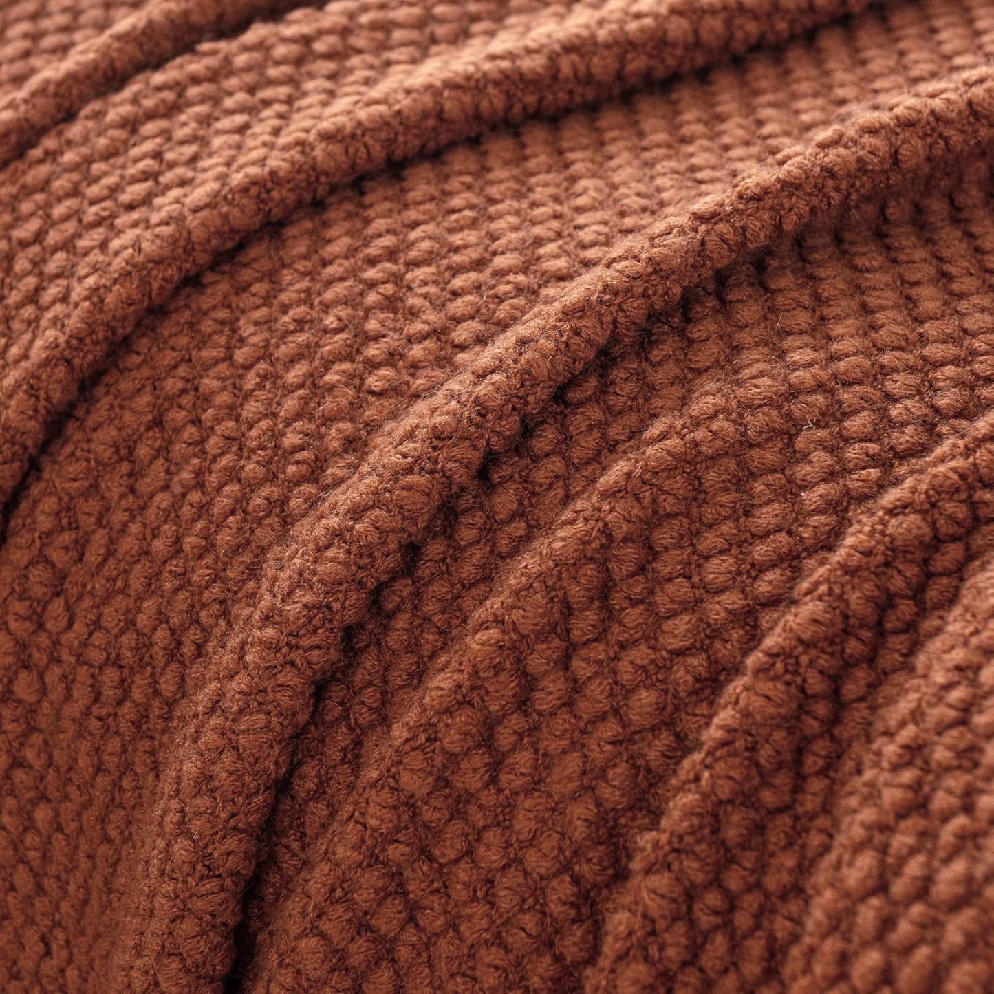 Terracotta micro plush knitted woven throw blanket with a cozy texture, perfect for adding warmth and style to your home decor.