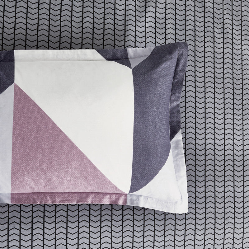 Modern geometric pillow on a quilted background, showcasing stylish design for quilt cover sets and duvet covers.