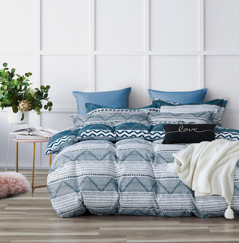 Stylish Jasper microfiber quilt cover set with blue and white patterns, featuring pillows and a cozy throw on a modern bed.