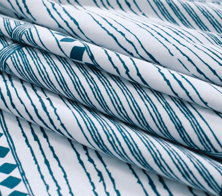 Close-up of Jasper microfiber quilt cover fabric featuring a modern striped pattern in teal and white.