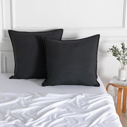 Luxurious black microfibre European pillowcases set on a bed with white sheets, perfect for vintage decor.