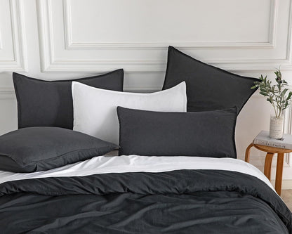 Luxurious vintage washed microfibre pillowcases in black and white atop a stylish bedding set, enhancing bedroom decor.