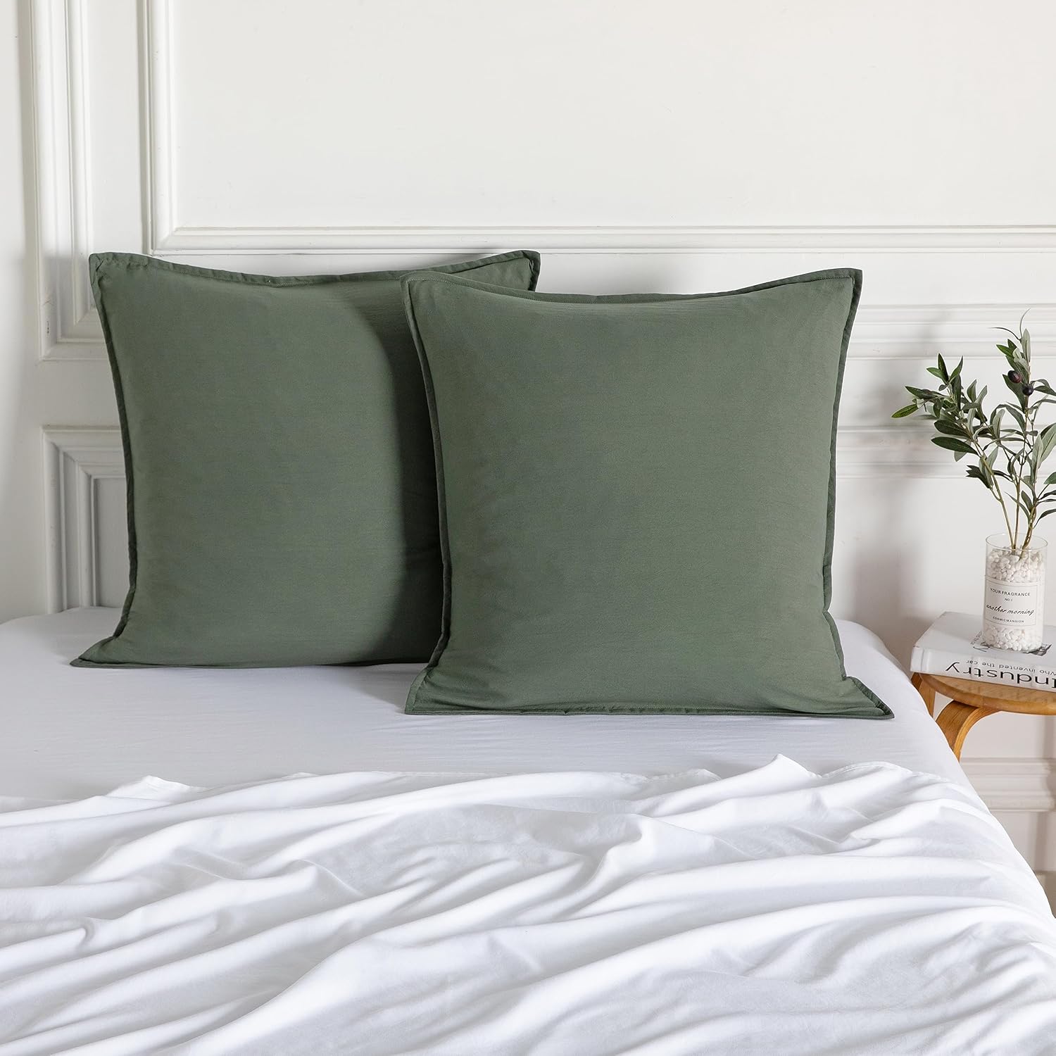 Luxurious khaki green vintage washed microfibre European pillowcases set on a cozy bed with white linens.