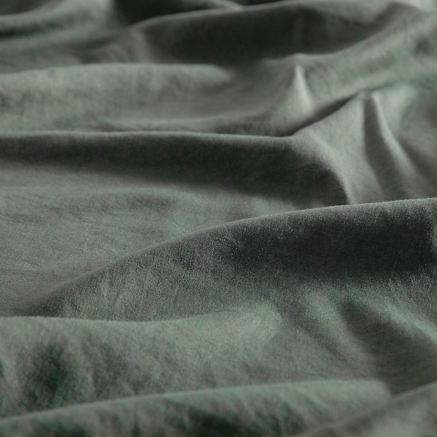 Close-up of khaki green vintage washed microfibre fabric, showcasing soft texture perfect for luxurious European pillowcases.