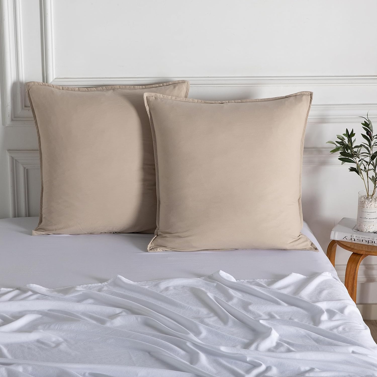 Luxurious vintage washed microfibre European pillowcases in soft beige on a neatly made bed.