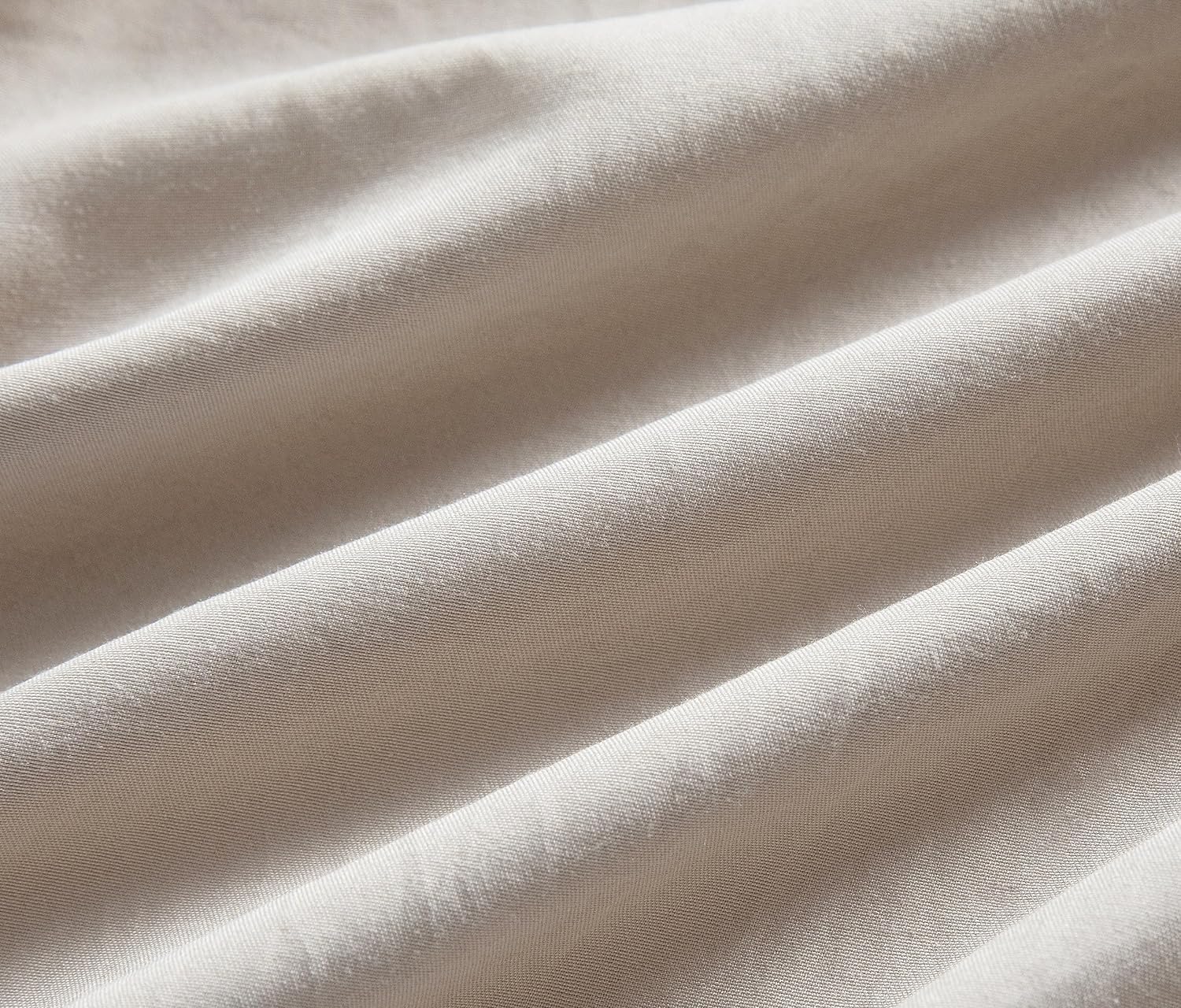 Close-up of luxurious white microfibre fabric, showcasing the soft texture and vintage washed design for pillowcases.