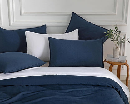 Luxurious vintage washed microfibre European pillowcases in navy on a stylish bed arrangement.