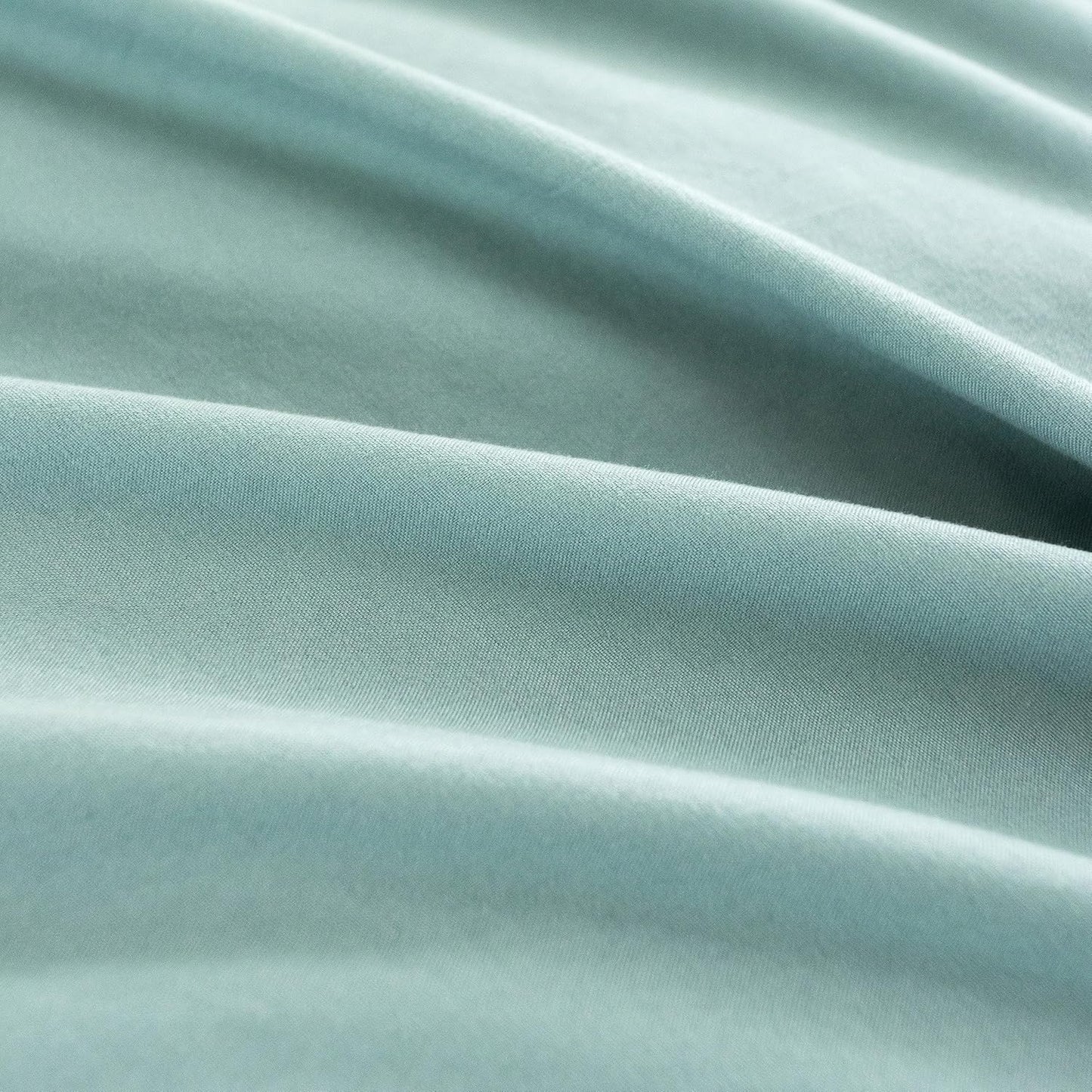 close-up of vintage washed microfibre fabric in soft seafoam color, ideal for luxurious European pillowcases.