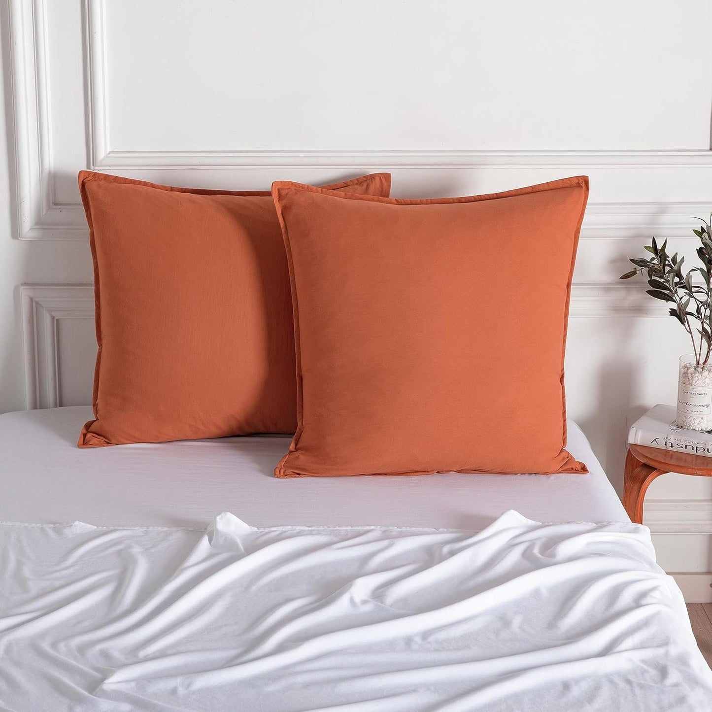 Luxurious terracotta microfibre European pillowcases on a white bed, enhancing bedroom decor and comfort.