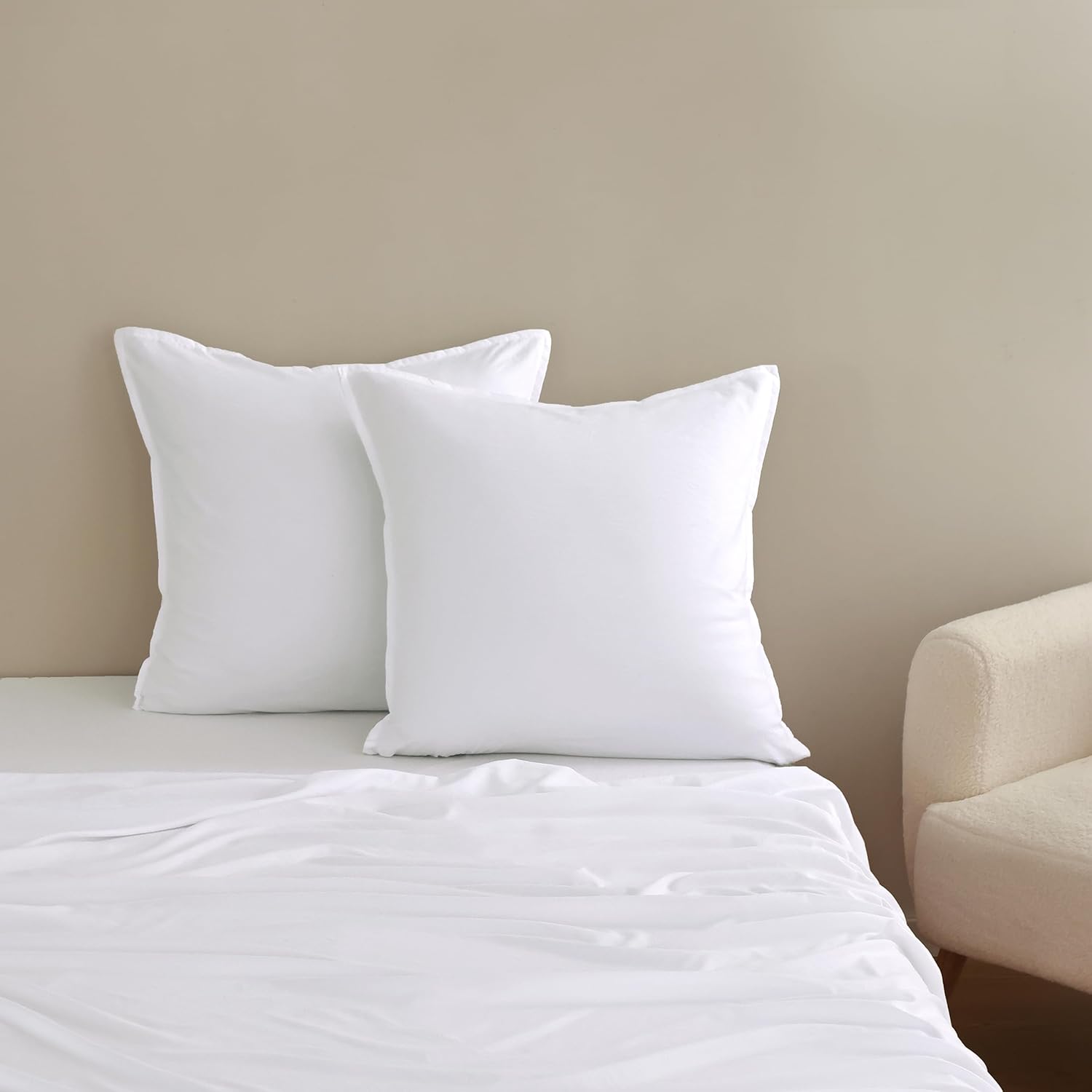 Vintage washed microfibre European pillowcases in luxurious white on a freshly made bed.