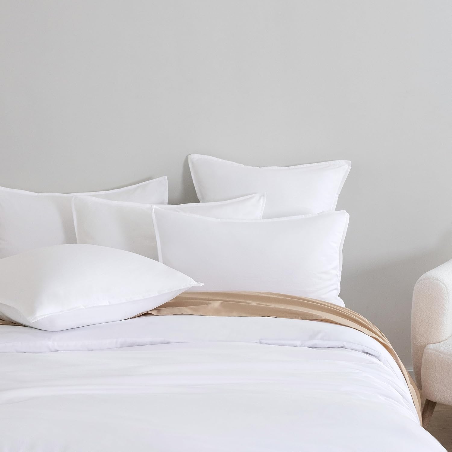 Luxurious white microfibre European pillowcases arranged on a cozy bed, adding elegance to bedroom decor.