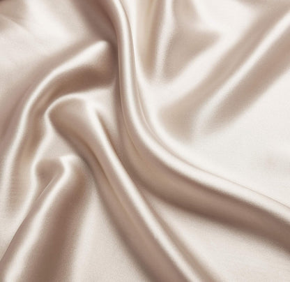 Luxurious champagne-colored mulberry silk fabric, smooth texture ideal for premium pillowcases and indulgent sleep experiences.