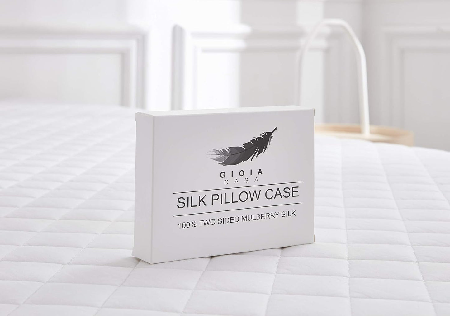 Luxury silk pillowcase box featuring 100% two-sided Mulberry silk on a stylish bed setting.