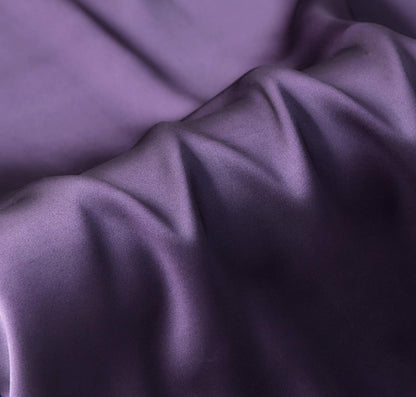 Dark purple luxury pillowcase made of 100% pure Mulberry silk, showcasing its smooth and lustrous surface.