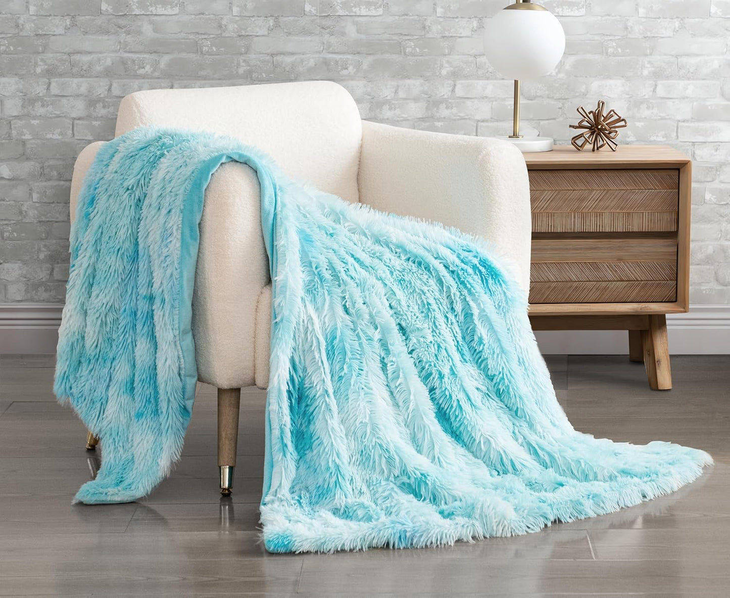 Blue faux fur shaggy throw blanket draped over a chair, featuring plush textures for cozy home decor.