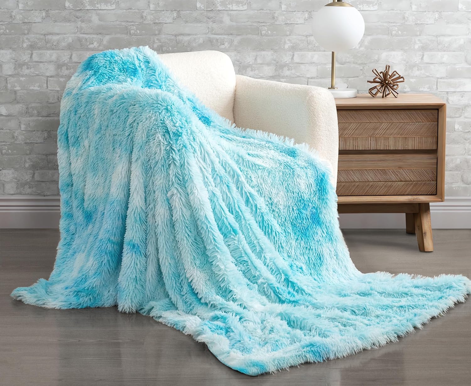 Blue double-sided faux fur shaggy throw blanket draped over a chair, adding cozy luxury to home decor.