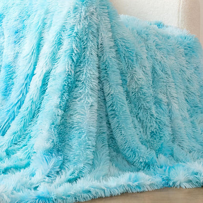 Blue faux fur shaggy throw blanket, reversible and plush, draped over furniture for cozy home comfort. Ideal for adding warmth and style.