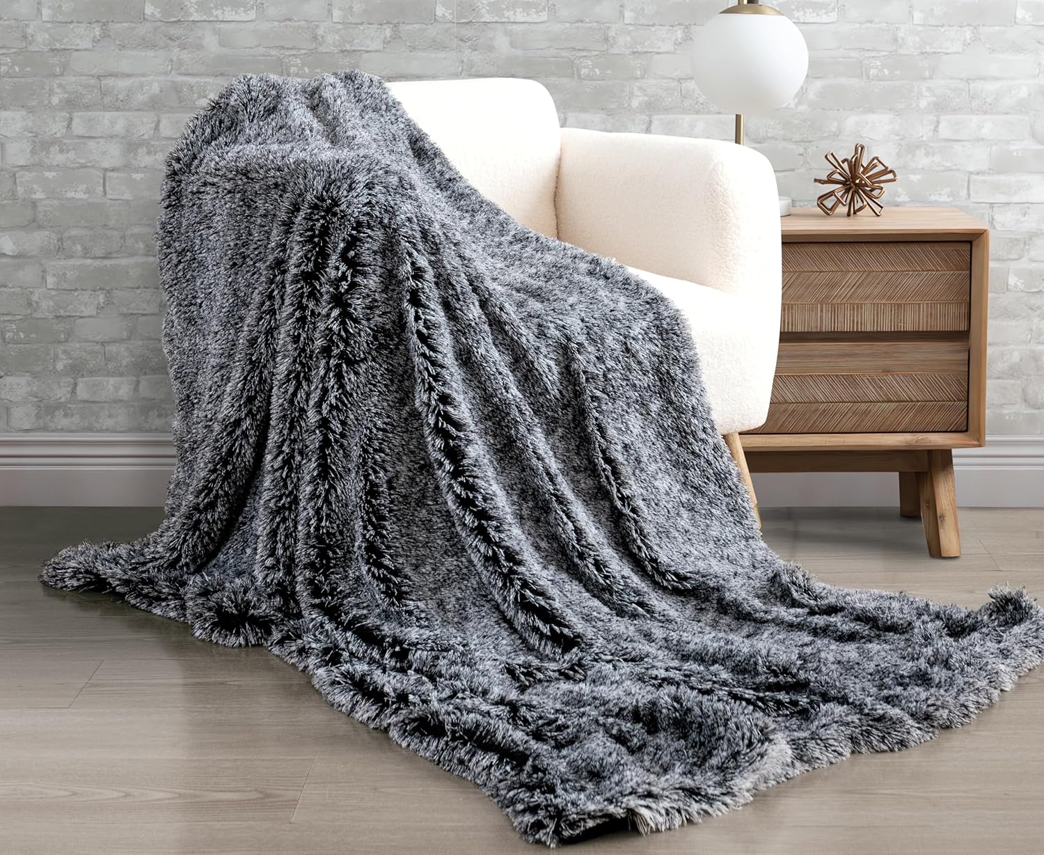 Charcoal faux fur shaggy throw blanket draped on a chair, showcasing its plush texture and warmth in a cozy living room setting.