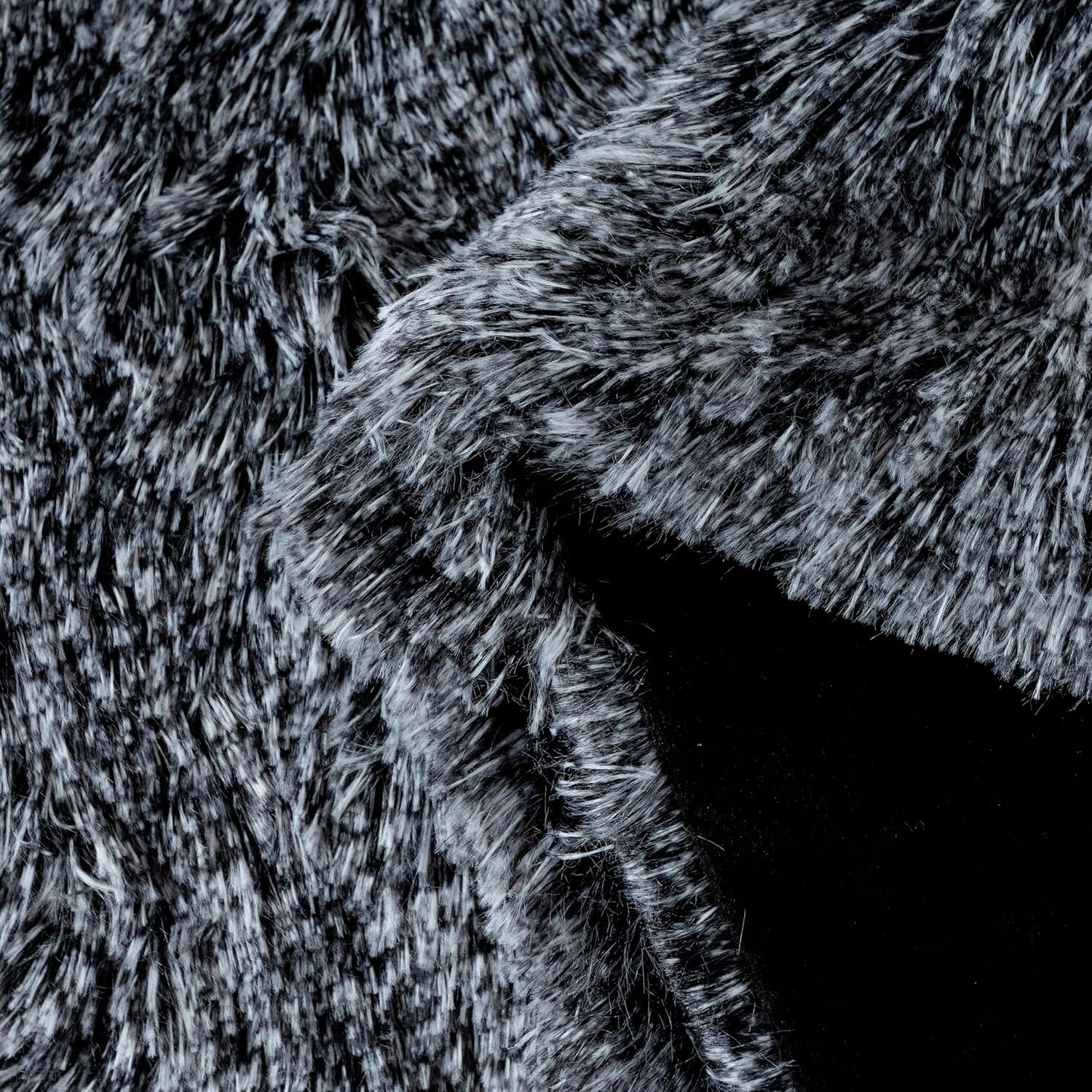 Charcoal faux fur throw blanket by Gioia Casa, showcasing plush shaggy texture and smooth microfibre velvet, perfect for cozy home comfort.