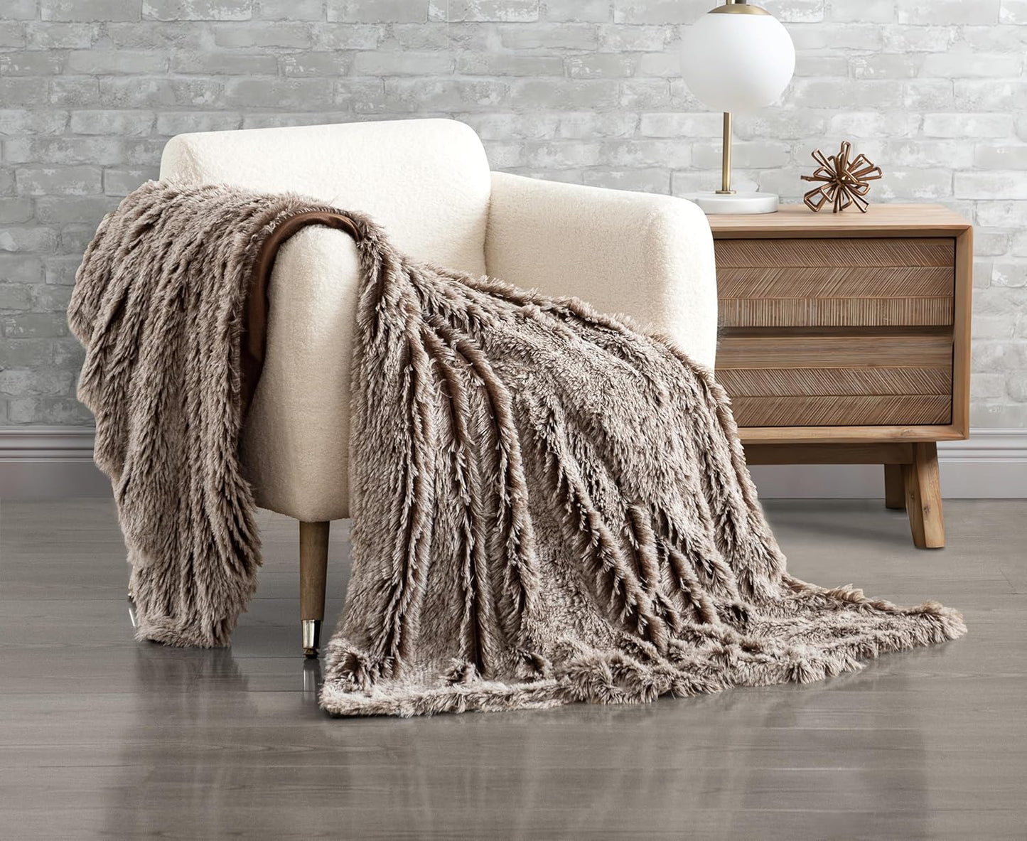 Chestnut faux fur shaggy throw blanket draped over a chair, showcasing plush texture and double-sided design for cozy home decoration.