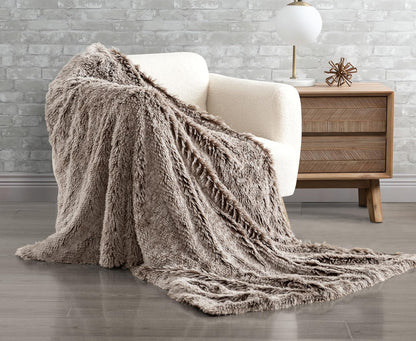 Chestnut faux fur throw blanket on chair, showcasing plush shaggy texture and reversible design for ultimate comfort and style.