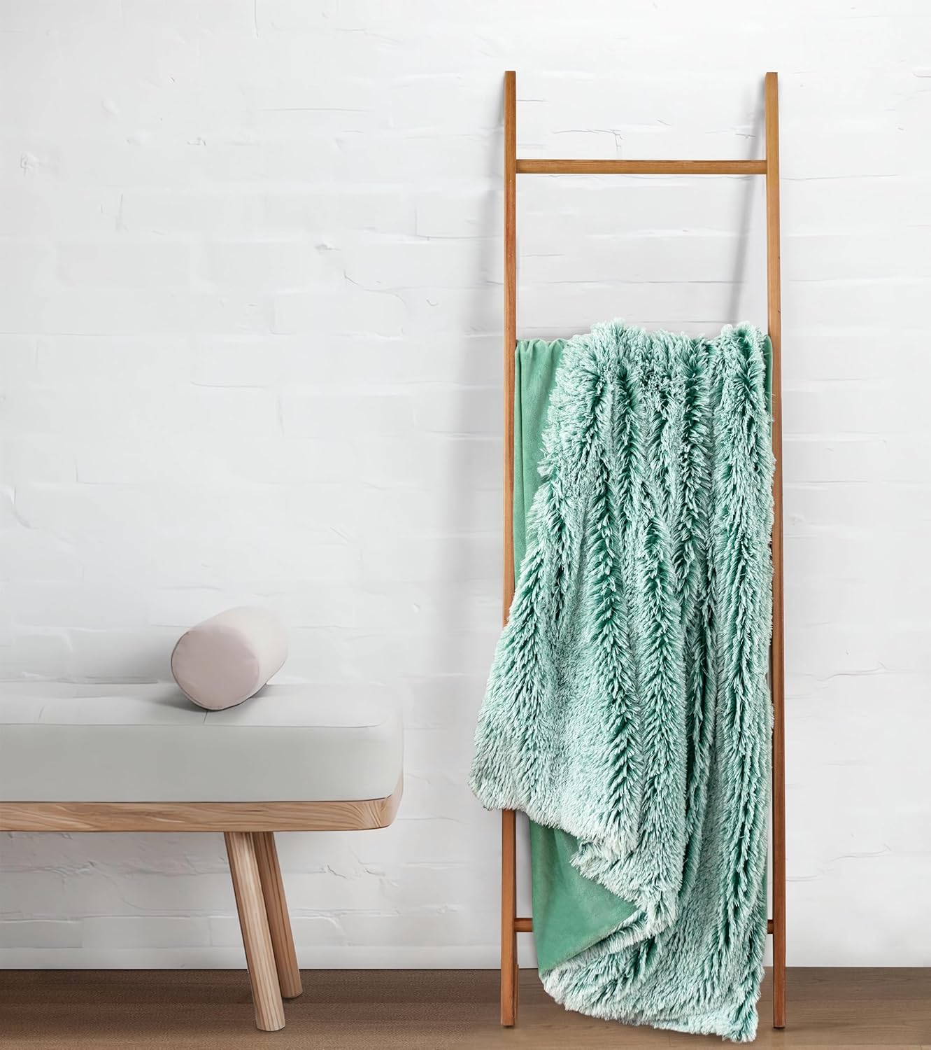 Premium Emerald Double-Sided Faux Fur Shaggy Throw Blanket on wooden ladder, showcasing soft plush texture and luxurious design.