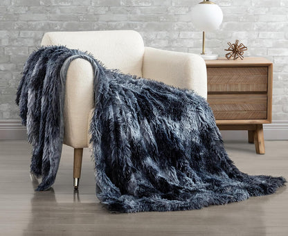 Navy faux fur shaggy throw blanket draped over a white chair, featuring double-sided plush and reversible design for cozy comfort.