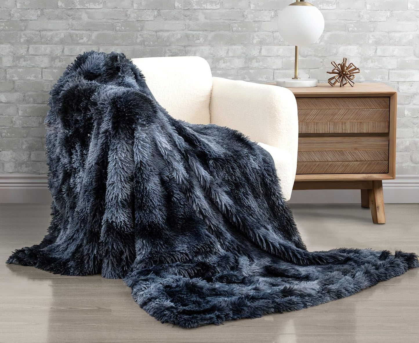 Navy double-sided faux fur shaggy throw blanket draped over a white chair, showcasing plush, luxurious texture and cozy warmth.