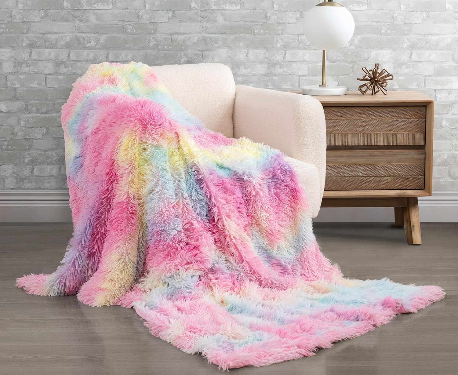 Rainbow faux fur shaggy throw blanket on chair, soft and luxurious for cozy comfort. Perfect for home decor with plush, reversible design.