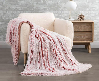 Rose faux fur shaggy throw blanket draped over a cream chair, adding cozy elegance to a modern living room.