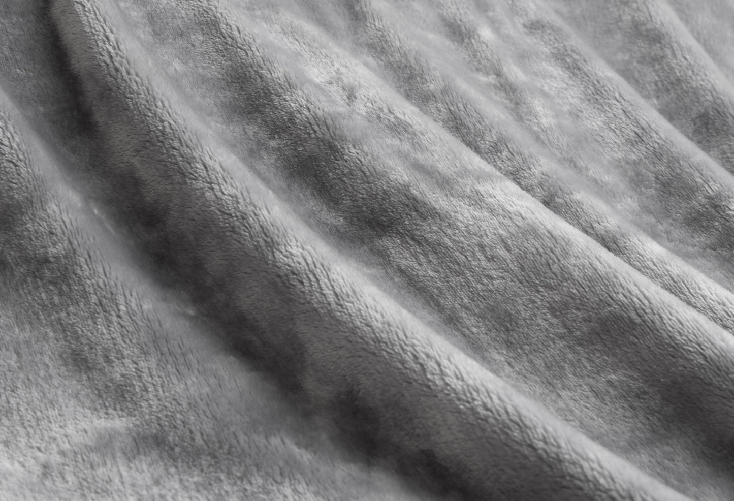 Close-up of a luxurious grey plush velvet blanket showcasing its soft texture and elegant design.