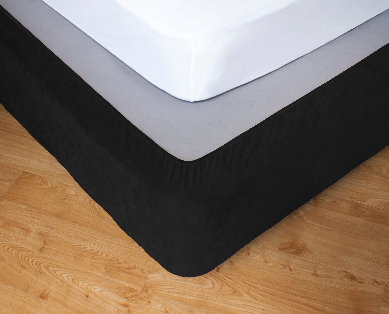 Stretch bedskirt valance in black covering king size bed, enhancing bedroom decor with a sleek and tailored look.