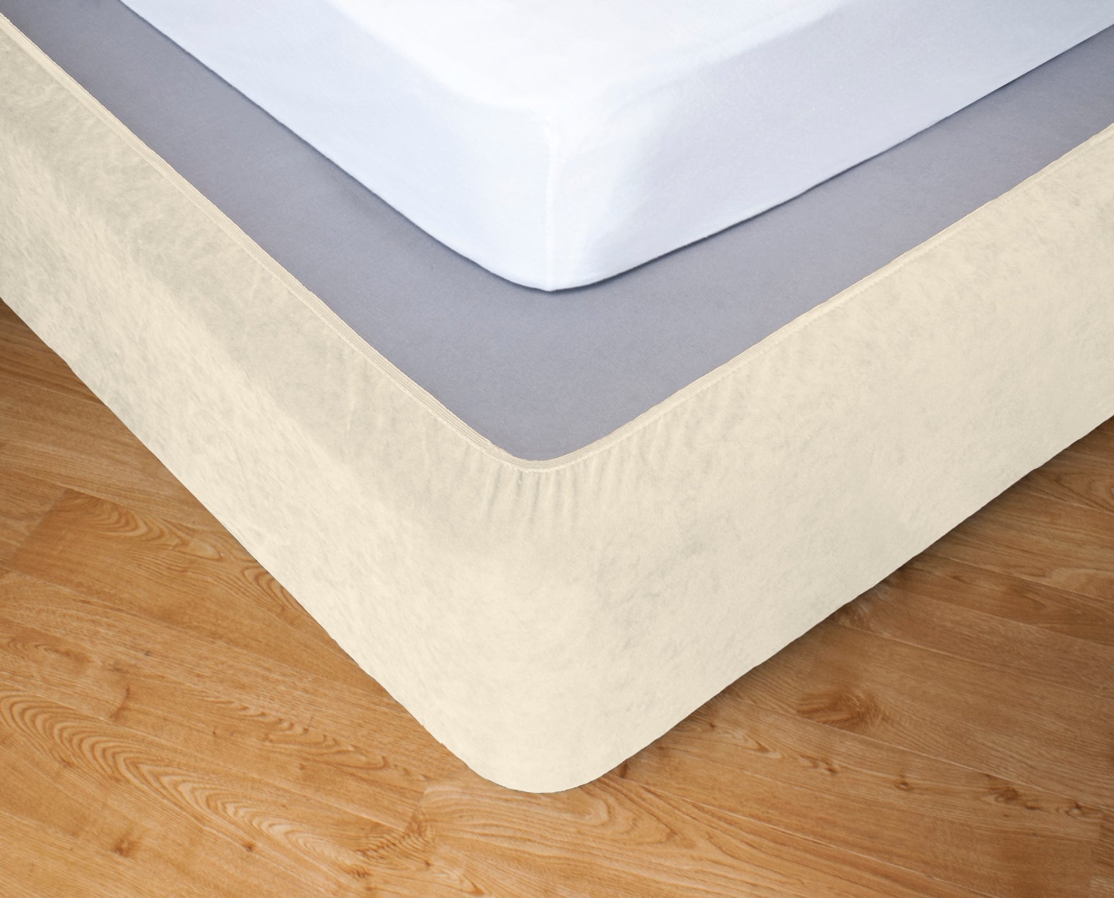 Stretch bedskirt valance in cream covering a single bed, adding elegance and a tailored look to the bedroom decor.