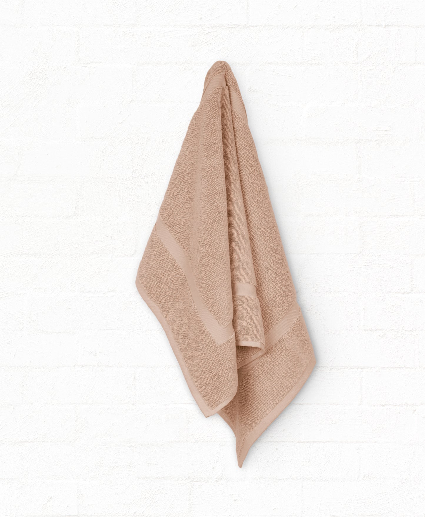 Peach cotton bath towel hanging on wall from St. Regis 7-piece luxury collection