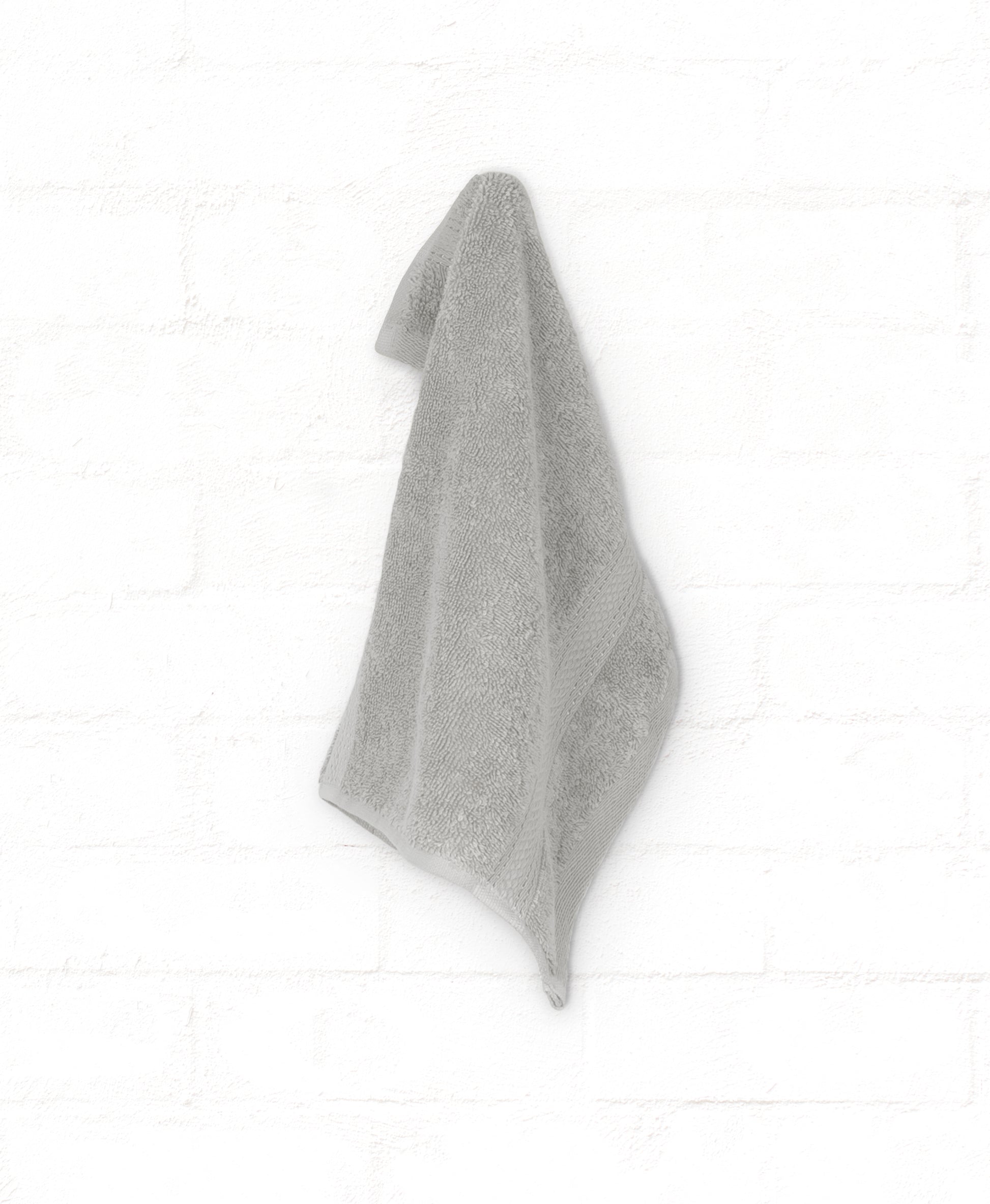 Grey cotton bath towel from the St. Regis 7-piece luxury towel set, hanging against a white background.