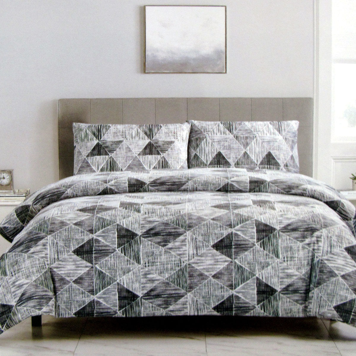 Charcoal black Avery lines pattern quilt cover set on queen bed, featuring geometric design in soft tones of white and black.