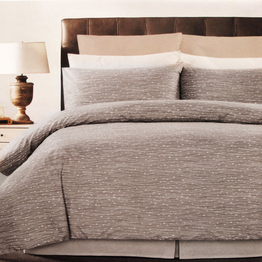 Weaves Coffee Easy Care Quilt Cover Set featuring a stylish gray weave design on a bed with pillows and a bedside lamp.