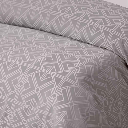 Elegant geometric jacquard pattern in taupe and silver on a quilt cover, perfect for modern bedroom decor.