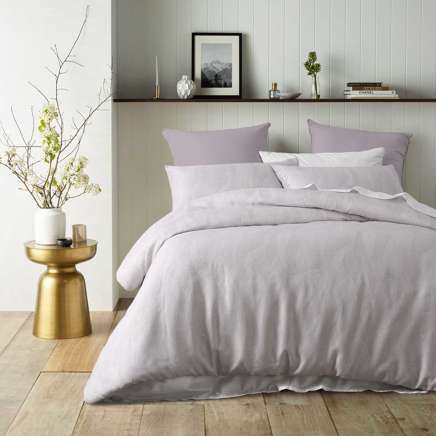 Elegant grey quilt cover set styled on a bed with matching pillows, ideal for modern bedroom decor.