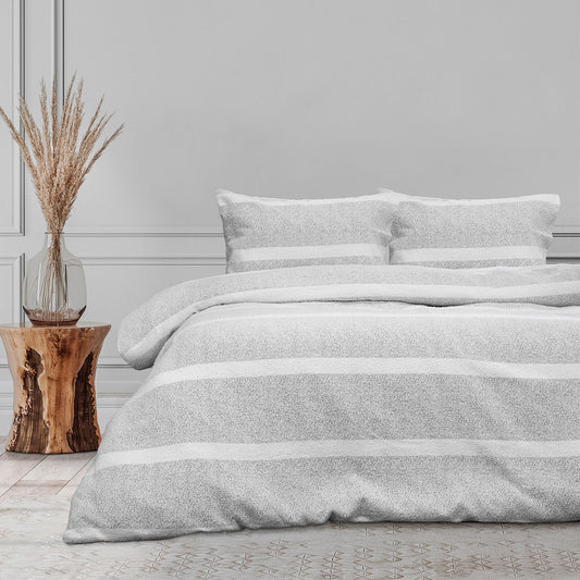 Textured grey quilt cover set with striped design on bed, featuring matching pillow covers and styled decor.