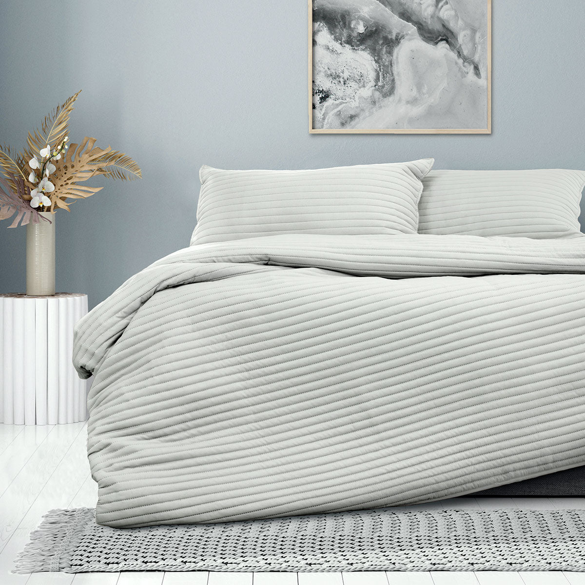 Ardor London Silver Embossed Quilt Cover Set on a bed, showcasing elegant design and soft textures for a stylish bedroom.