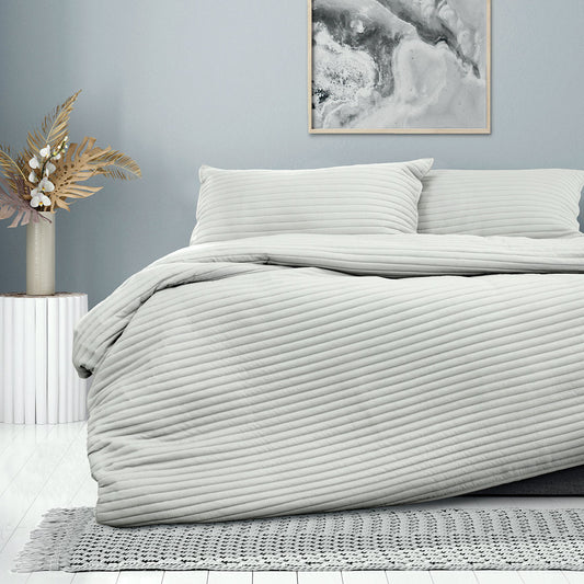 Ardor London Silver Embossed Quilt Cover Set on a bed, showcasing elegant design and soft textures for a stylish bedroom.