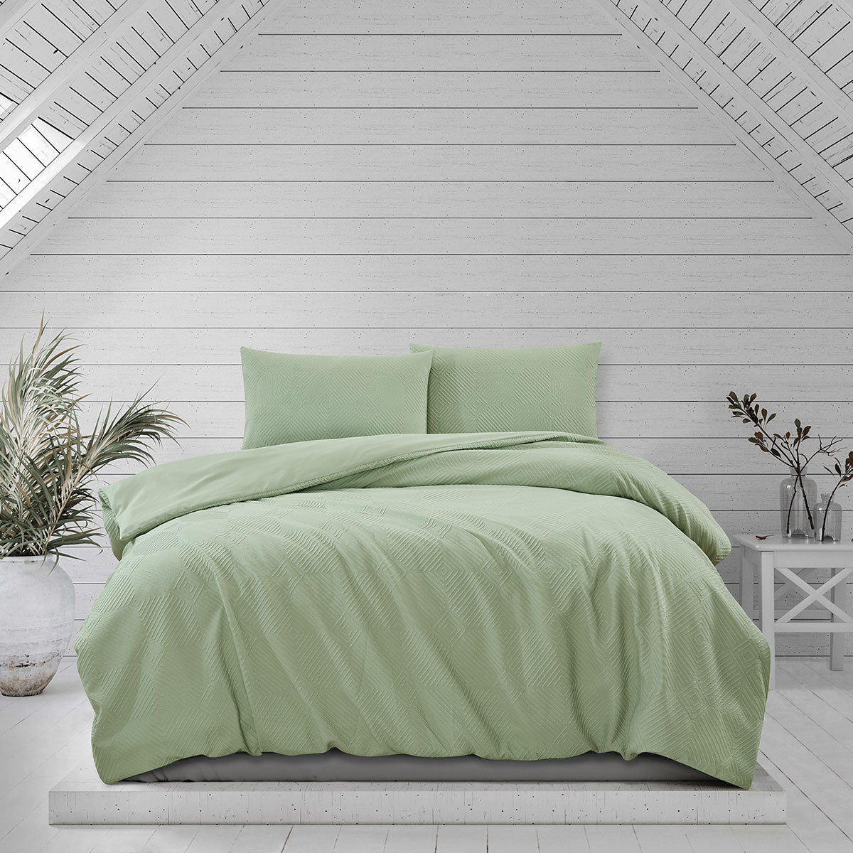 Ardor Preston Pale Green Embossed Quilt Cover Set displayed in a stylish bedroom with coastal decor.