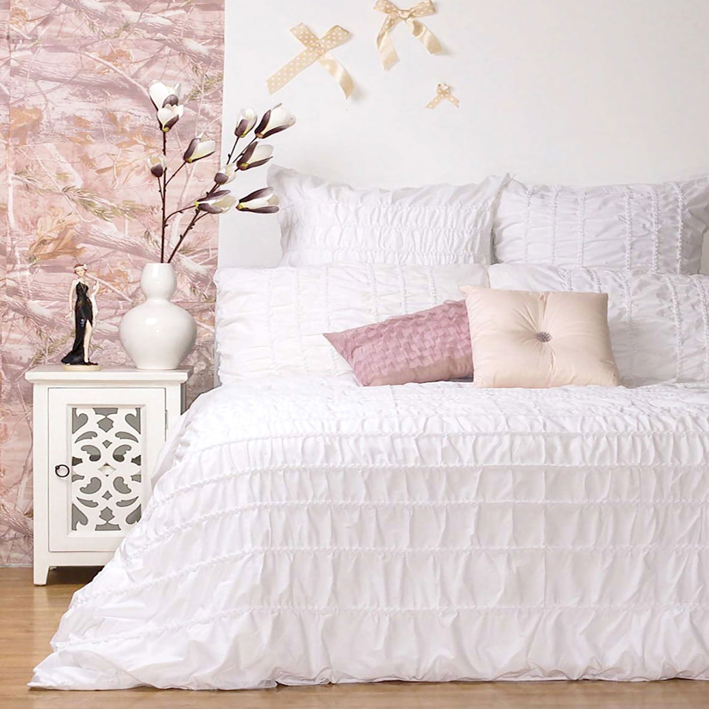 White quilt cover set on a stylish bed with decorative pillows and bedside table, enhancing cozy bedroom decor.