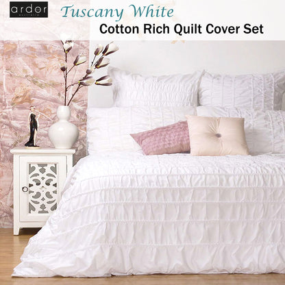 Tuscany White Cotton Quilt Cover Set on a bed with decorative pillows, enhancing bedroom style and comfort.