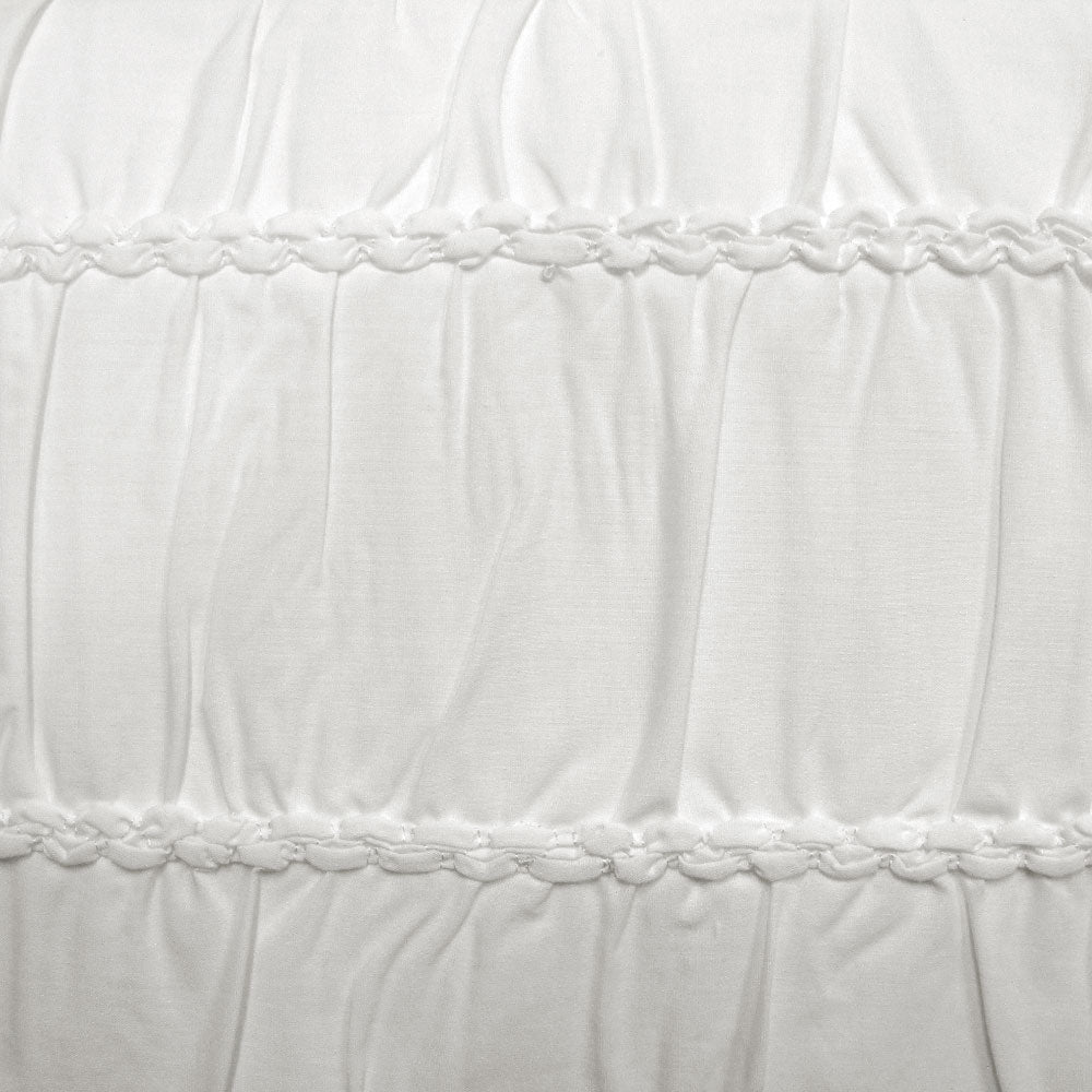 Close-up of textured white quilt cover featuring stitched detailing, perfect for enhancing bedroom aesthetics.