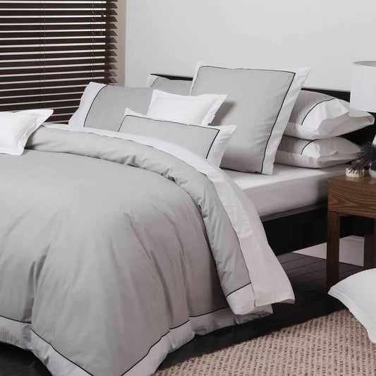 Logan and Mason Essex Pewter Cotton-rich Quilt Cover Set in a refined herringbone pattern with white contrast border on bed.