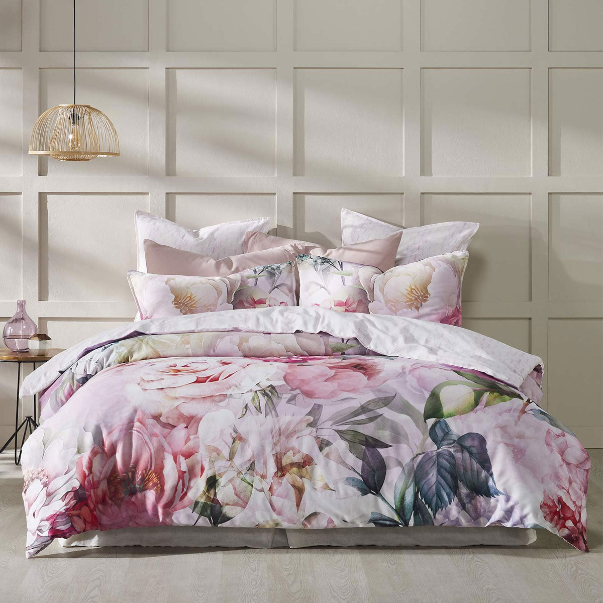 Logan and Mason 250TC Summer Daze Pink Cotton Sateen Quilt Cover Set on a bed with floral pattern and matching pillows.