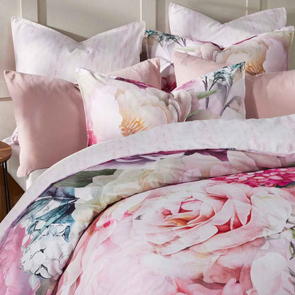 Floral quilt cover set with pink and cream hues featuring decorative pillows for a stylish bedroom look.