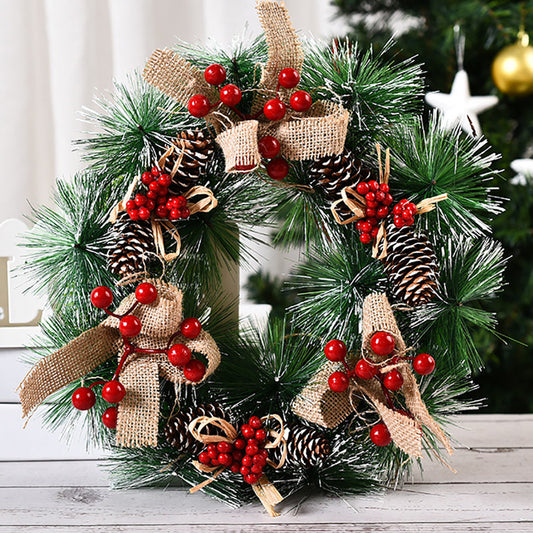 Festive Christmas wreath featuring red berries and rustic bows, perfect for holiday door or wall decoration.